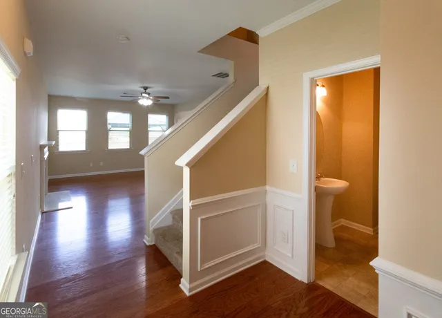 a view of entryway and hall with wooden floor