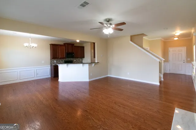 a view of a kitchen with a sink a kitchen microwave and cabinets