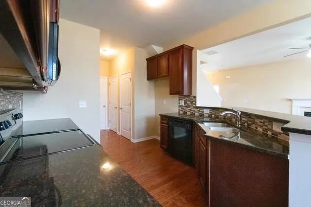 a kitchen with a sink stove and refrigerator