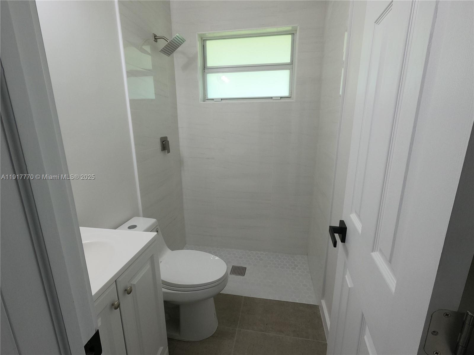 26633 Southwest 138th Court Homestead, FL 33032 - Photo 12 of 58 a bathroom with a toilet a sink and shower