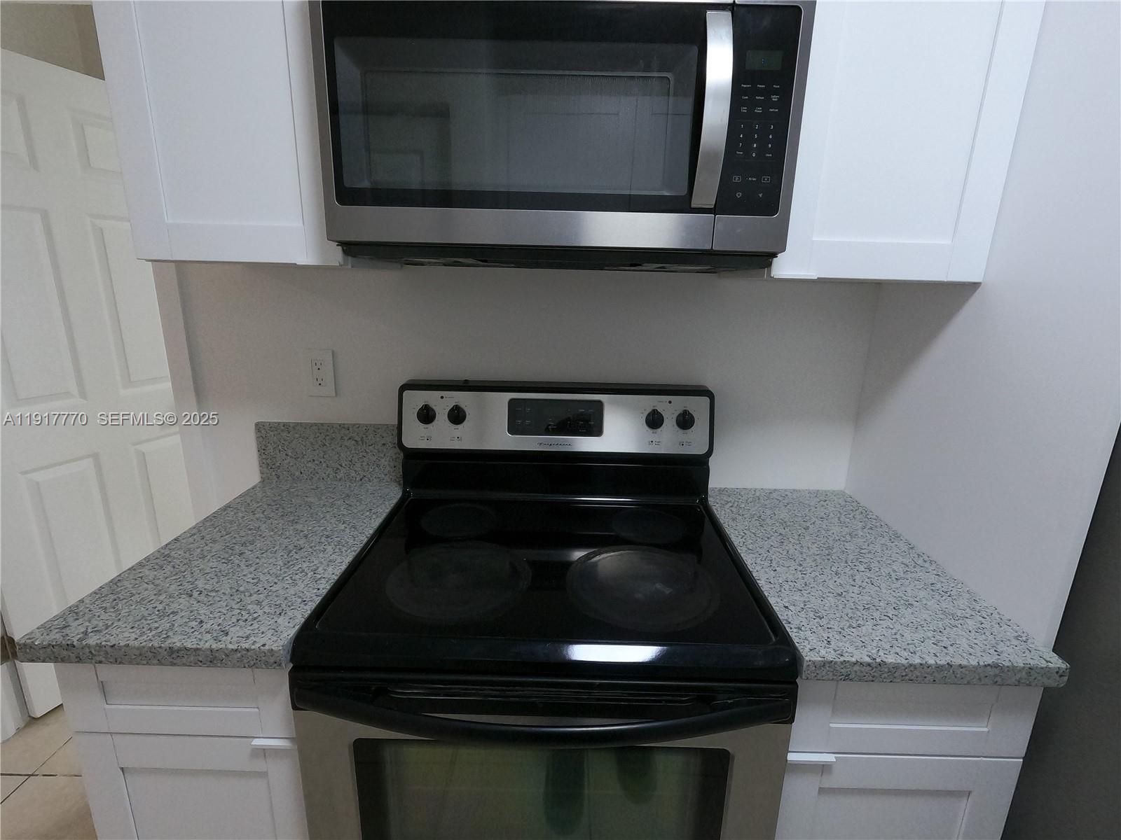 26633 Southwest 138th Court Homestead, FL 33032 - Photo 15 of 58 a stove top oven sitting inside of a kitchen
