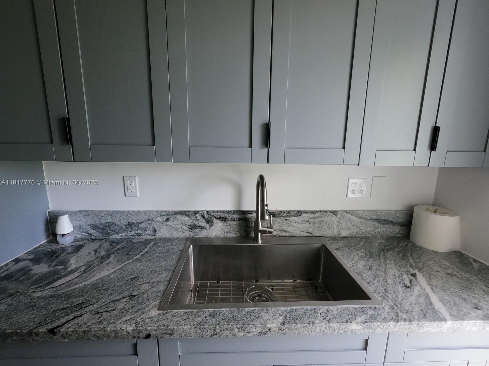 26633 Southwest 138th Court Homestead, FL 33032 - Photo 18 of 58 a kitchen with a sink and cabinets