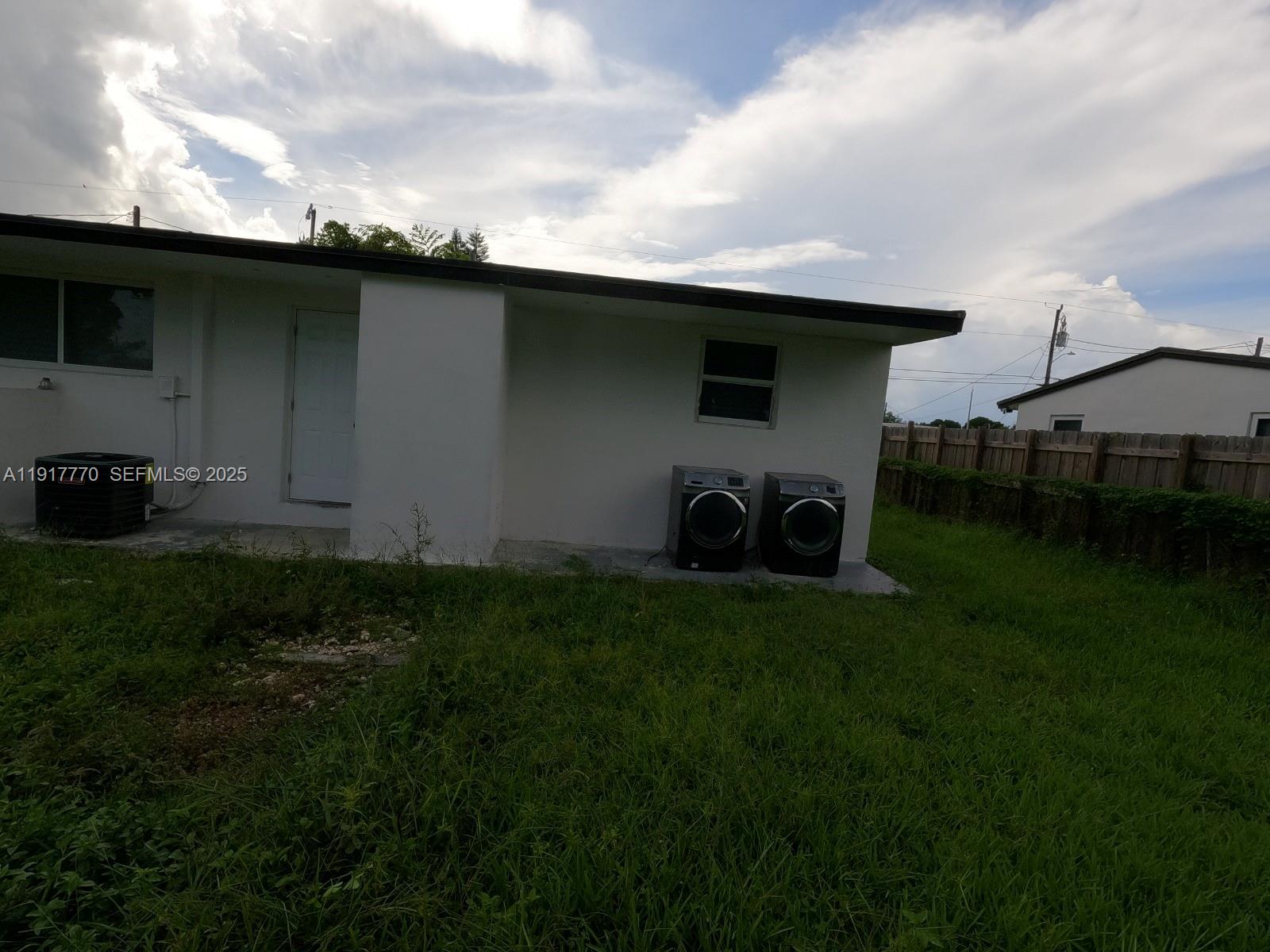 26633 Southwest 138th Court Homestead, FL 33032 - Photo 20 of 58 a backyard of a house with table and chairs