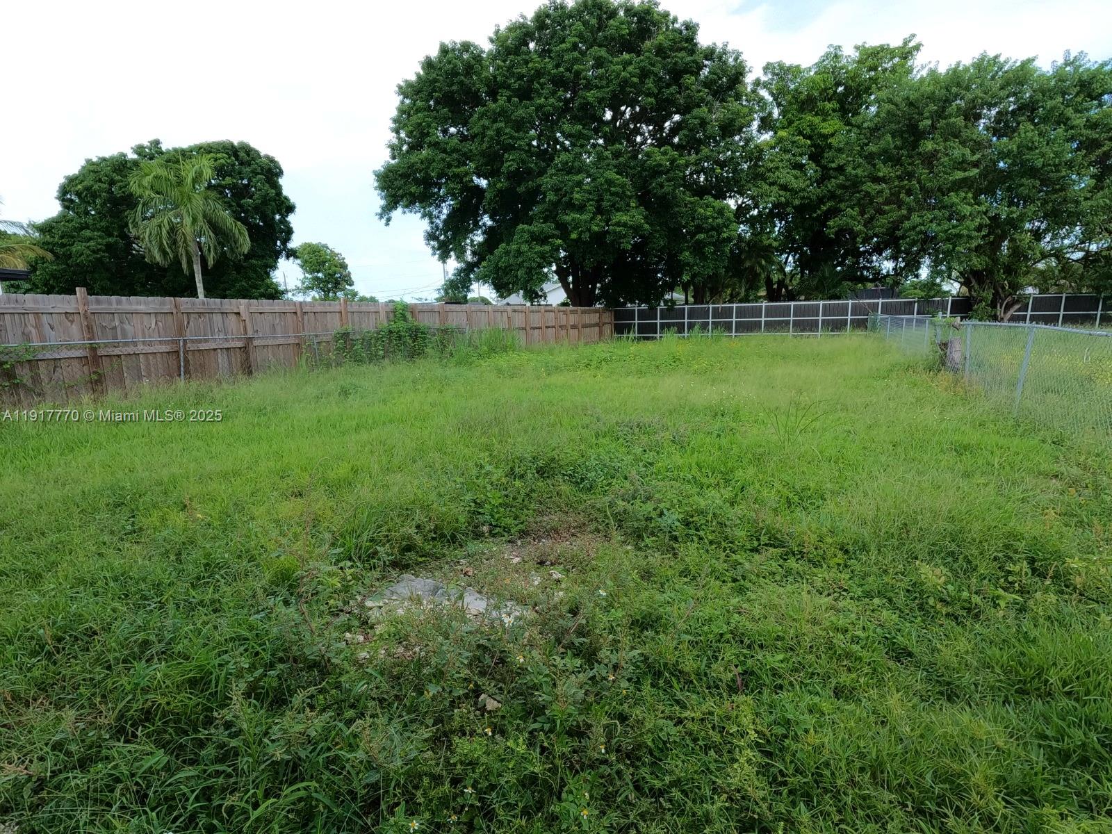 26633 Southwest 138th Court Homestead, FL 33032 - Photo 24 of 58 a view of a field with trees in the background