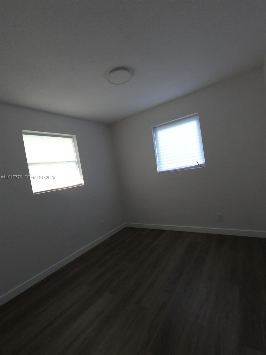 26633 Southwest 138th Court Homestead, FL 33032 - Photo 29 of 58 a view of an empty room with wooden floor and a window