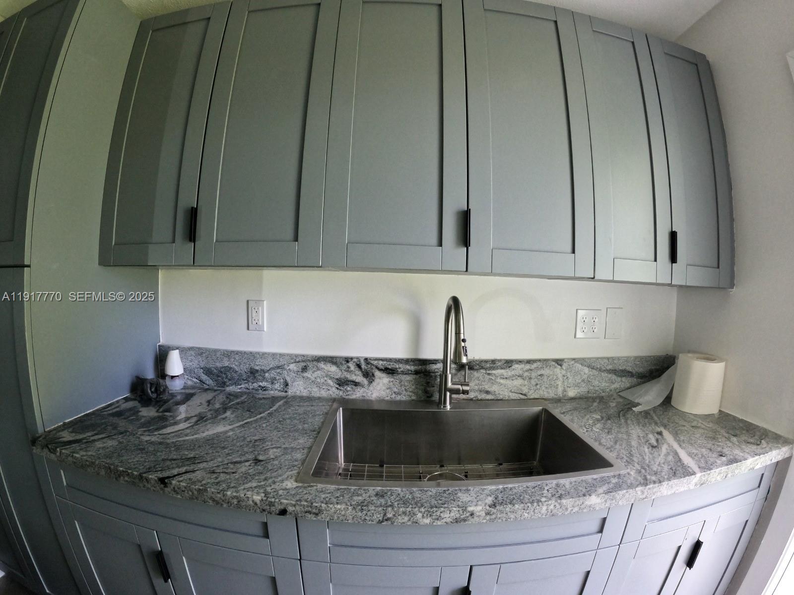 26633 Southwest 138th Court Homestead, FL 33032 - Photo 35 of 58 a kitchen with granite countertop a sink a stove and cabinets