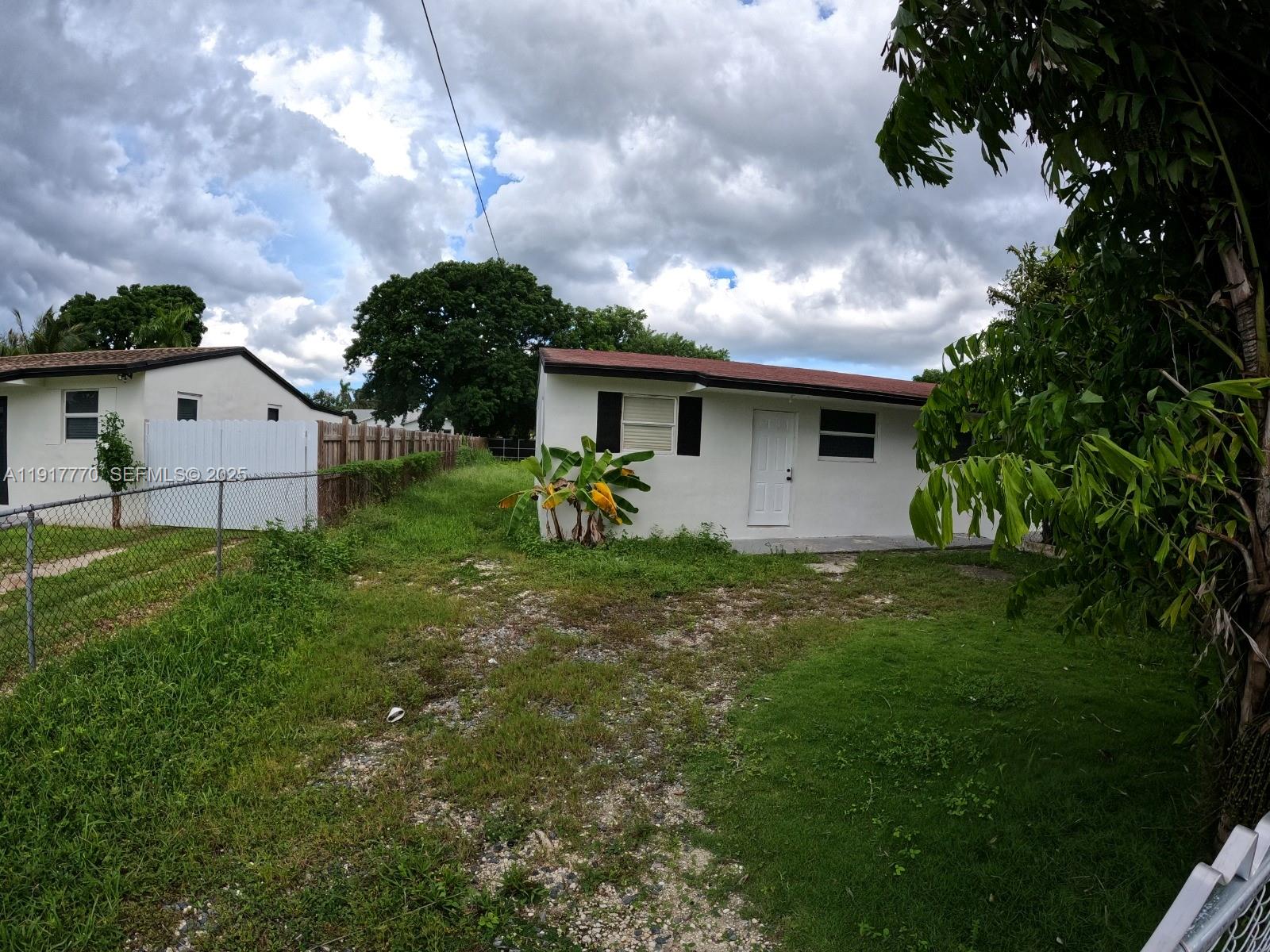 26633 Southwest 138th Court Homestead, FL 33032 - Photo 50 of 58 a front view of house with yard and trees