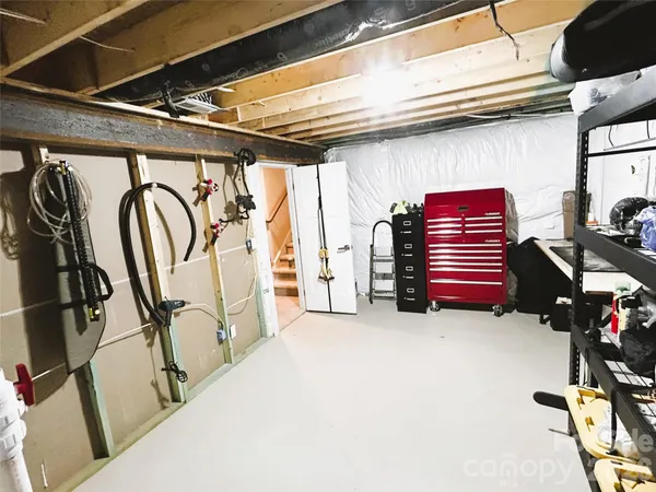 a bedroom with a bed and a refrigerator