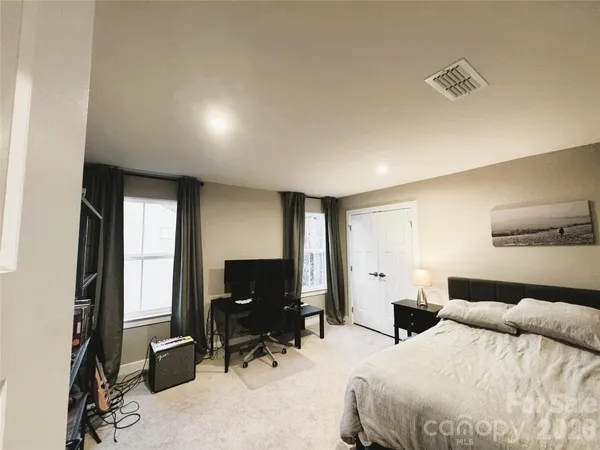 a spacious bathroom with a double vanity sink a large mirror and a bathtub