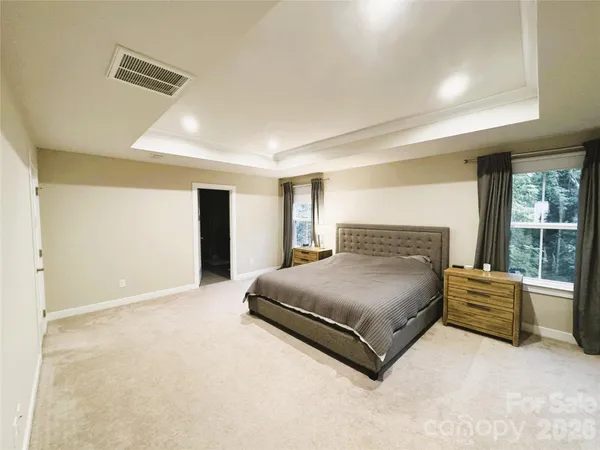 a bedroom with a bed and a television