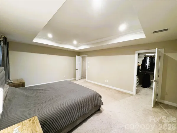 a spacious bathroom with a double vanity sink a mirror and a shower