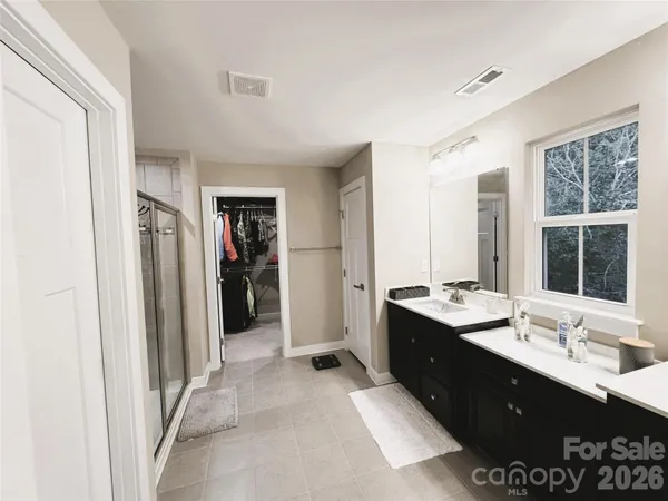 a bathroom with a glass shower door