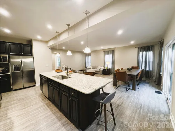 a large kitchen with a table and chairs
