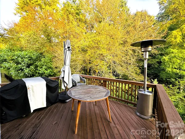 a view of balcony with wooden floor and outdoor seating