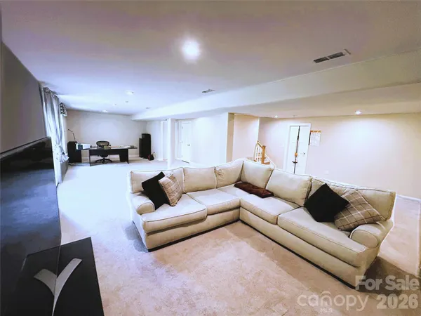 a large bathroom with a tub sink and mirror