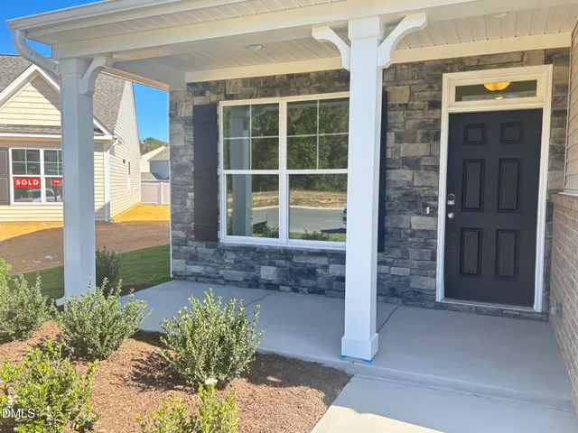 a view of a brick house with potted plants
