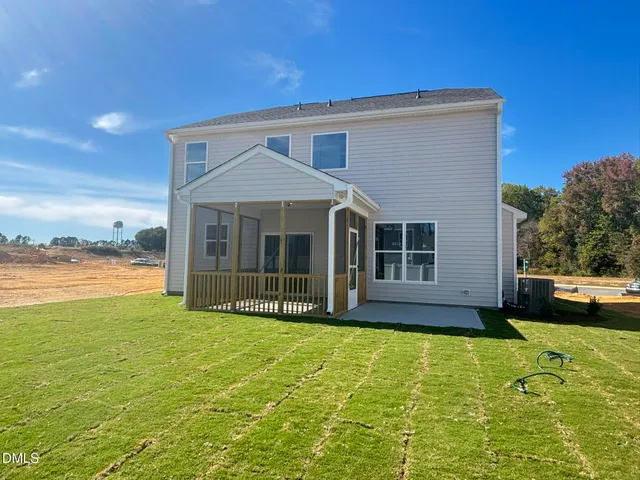 a view of a house with a yard and a fountain