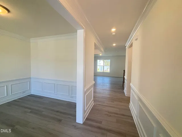 a view of hallway with wooden floor
