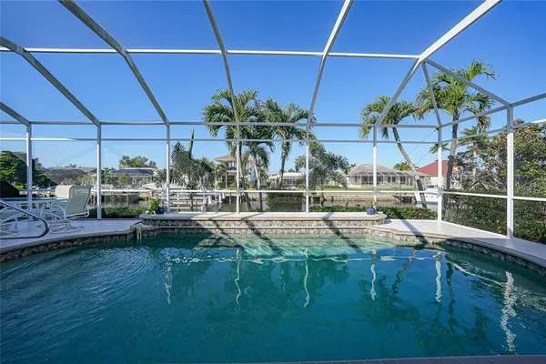 a view of swimming pool with outdoor seating and plants