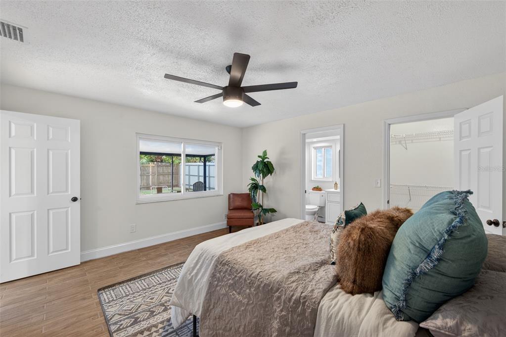 3733 Coppertree Circle Brandon, FL 33511 - Photo 15 of 45 a bed room with a bed a chandelier and a window