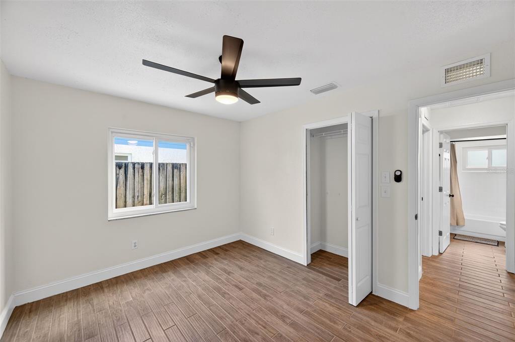 3733 Coppertree Circle Brandon, FL 33511 - Photo 21 of 45 a view of an empty room with wooden floor and a window