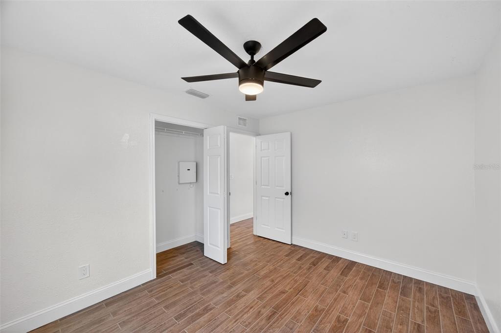 3733 Coppertree Circle Brandon, FL 33511 - Photo 22 of 45 a view of a livingroom with wooden floor and a ceiling fan