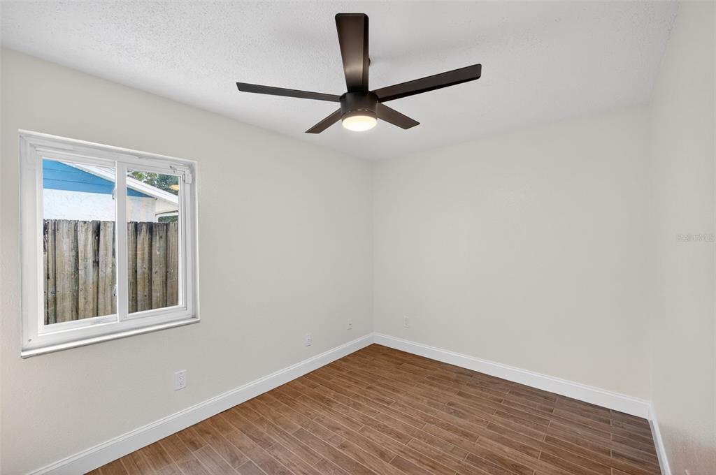 3733 Coppertree Circle Brandon, FL 33511 - Photo 25 of 45 a view of empty room with wooden floor and fan