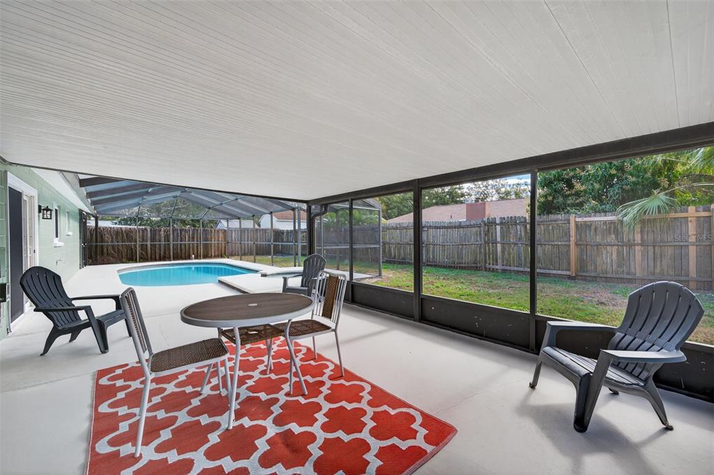 3733 Coppertree Circle Brandon, FL 33511 - Photo 38 of 45 a living room with furniture and a floor to ceiling window