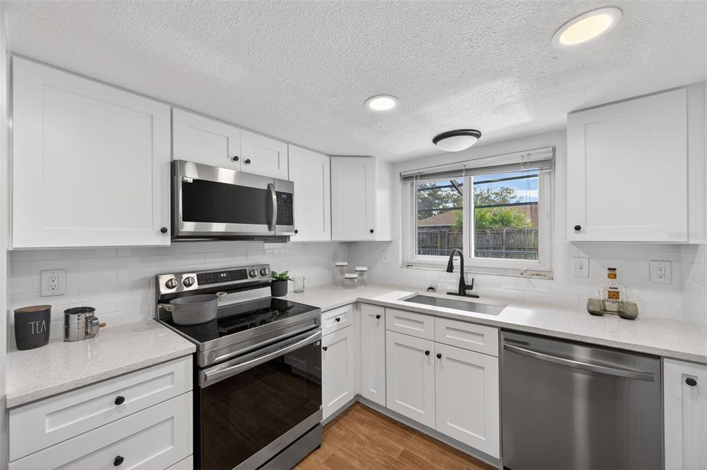 3733 Coppertree Circle Brandon, FL 33511 - Photo 7 of 45 a kitchen with a sink stainless steel appliances and cabinets