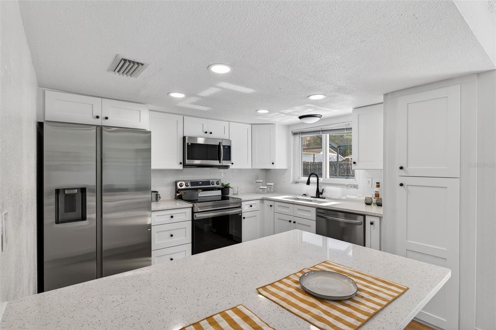 3733 Coppertree Circle Brandon, FL 33511 - Photo 8 of 45 a kitchen with stainless steel appliances granite countertop a refrigerator stove top oven and sink