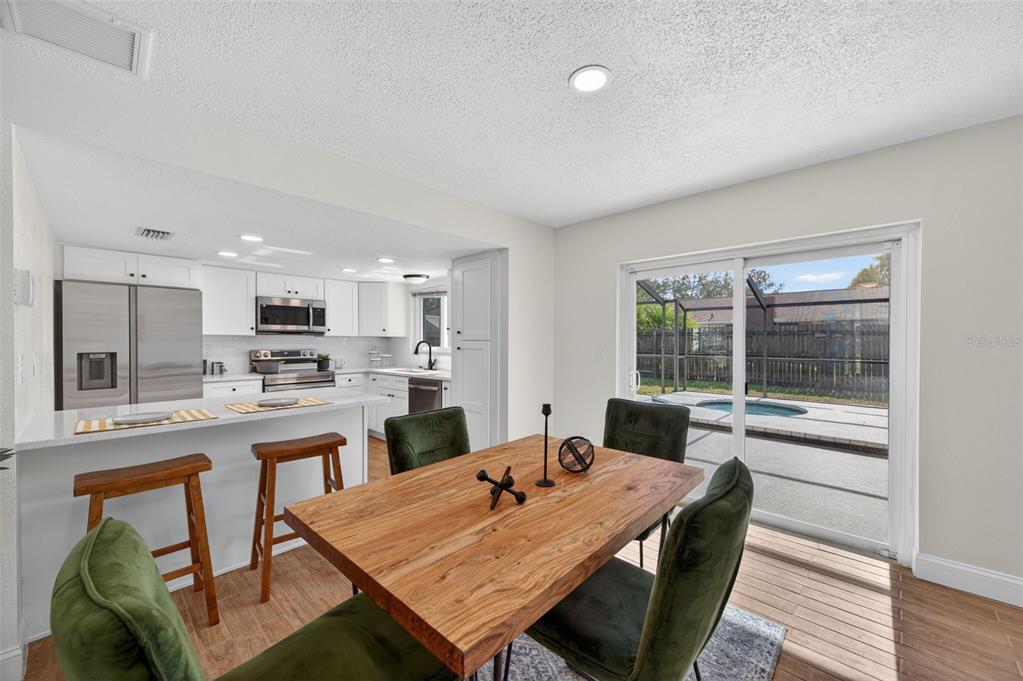 3733 Coppertree Circle Brandon, FL 33511 - Photo 10 of 45 a view of a dining room with furniture window and wooden floor