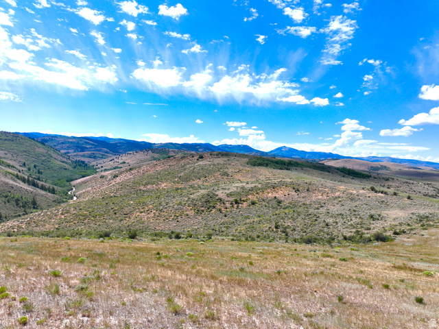 160 Dry Canyon St. Charles, ID 83272 - Photo 3 of 63 Expansive natural landscape with rolling hills, distant mountains, and a visible stream