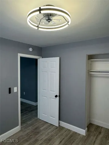 an empty room with wooden floor and closet