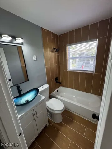 a bathroom with a bathtub and a window