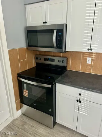 a stove top oven sitting inside of a kitchen