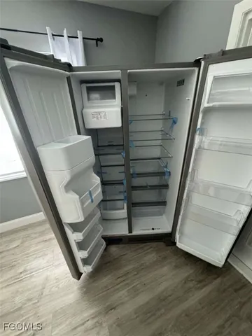 a view of walk in closet with wooden floor and stairs
