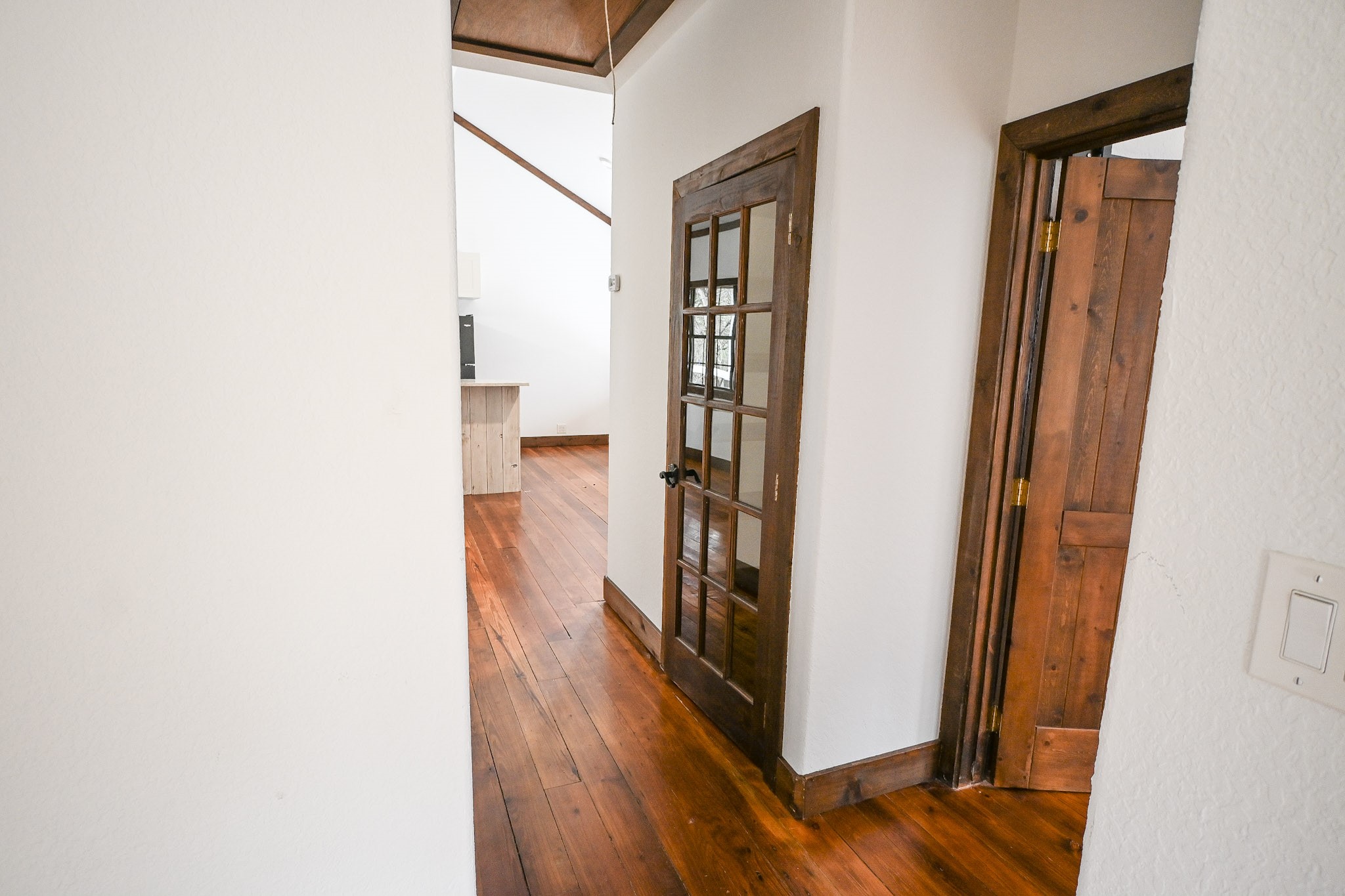 15104 Texas Street Austin, TX 78734 - Photo 7 of 18 a view of a hallway with wooden floor and staircase