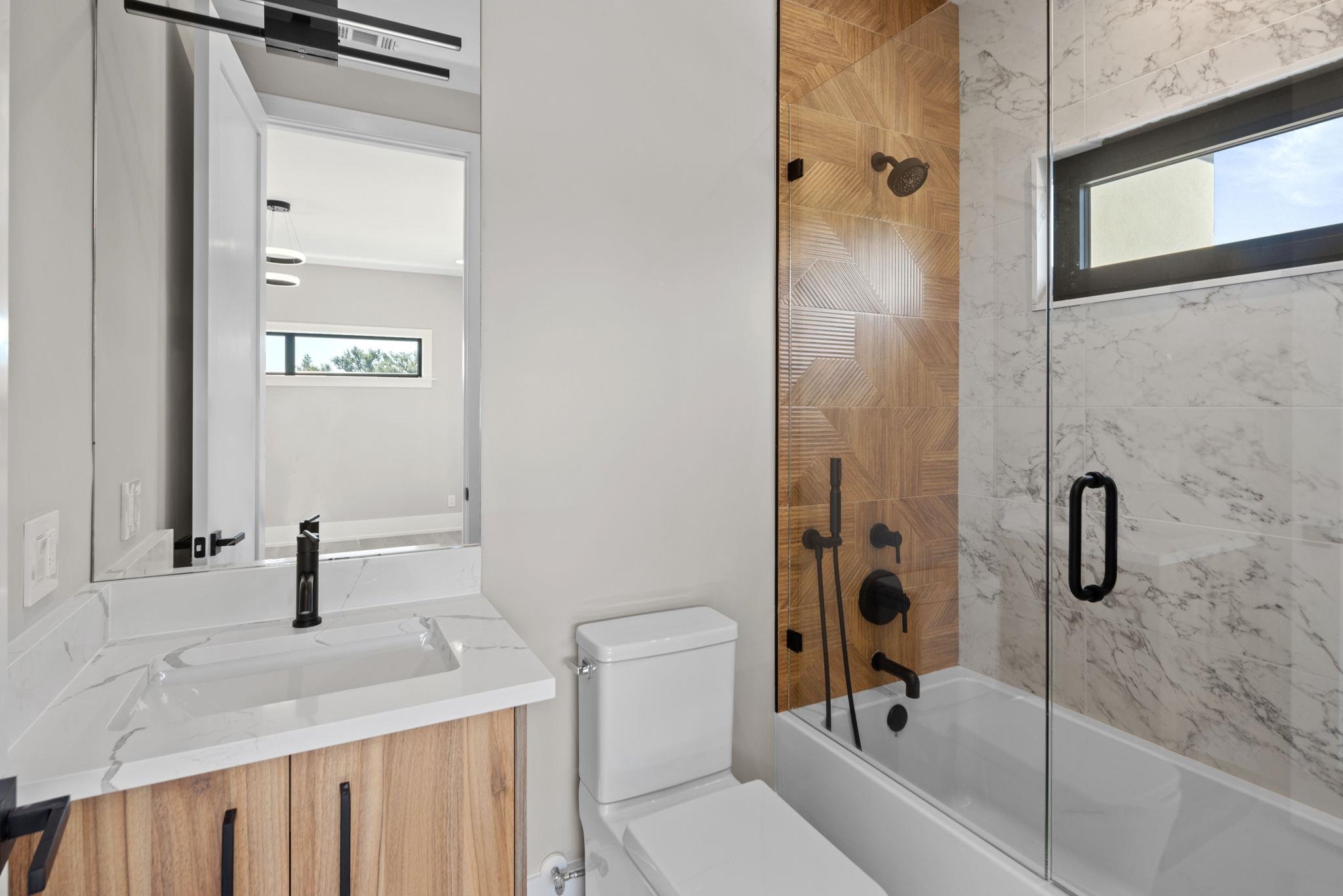 583 Comanche Ridge Round Mountain, TX 78663 - Photo 16 of 30 a bathroom with a sink a toilet and shower
