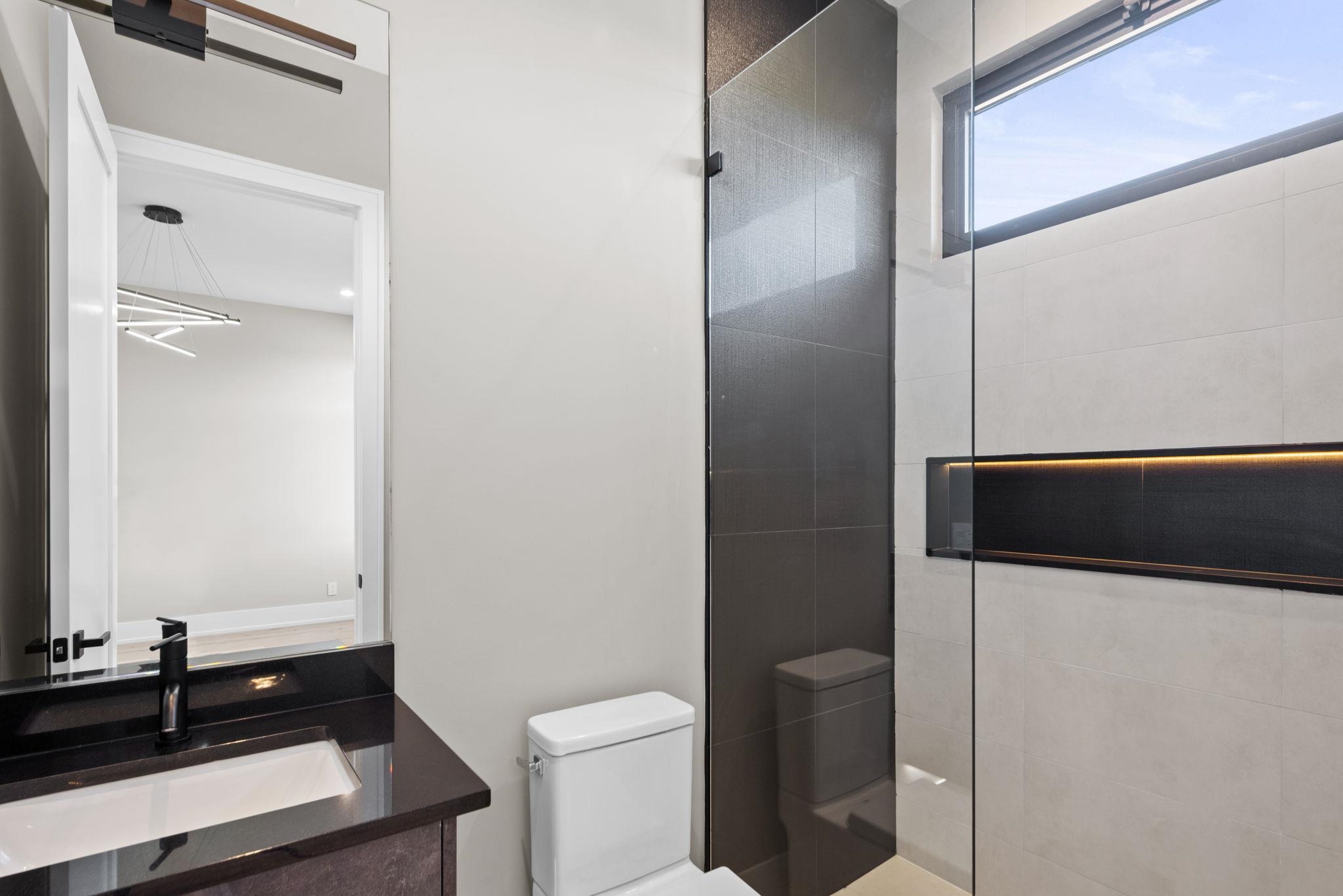 583 Comanche Ridge Round Mountain, TX 78663 - Photo 18 of 30 a bathroom with a toilet a sink and a mirror