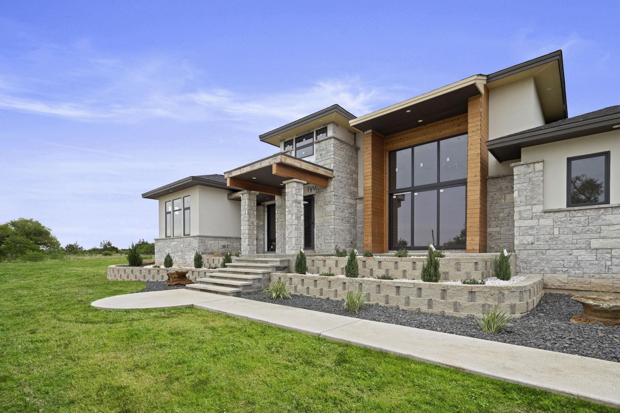 583 Comanche Ridge Round Mountain, TX 78663 - Photo 2 of 30 a front view of a house with garden