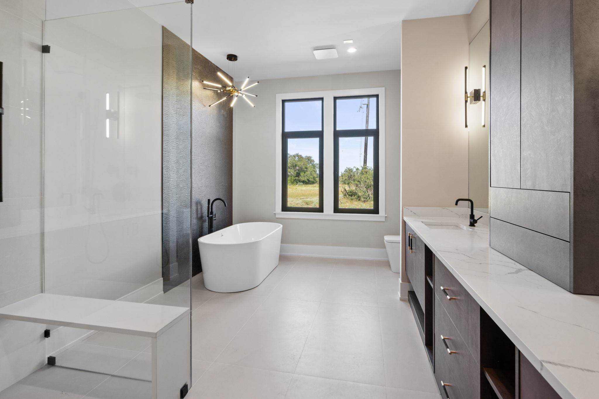 583 Comanche Ridge Round Mountain, TX 78663 - Photo 21 of 30 a bathroom with a double vanity sink toilet and shower