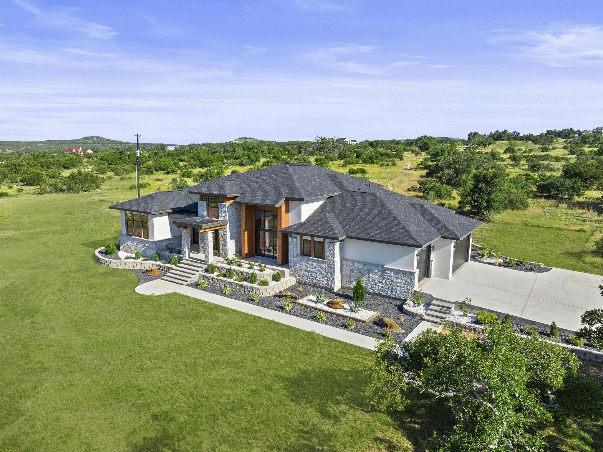 583 Comanche Ridge Round Mountain, TX 78663 - Photo 30 of 30 a front view of a house with garden