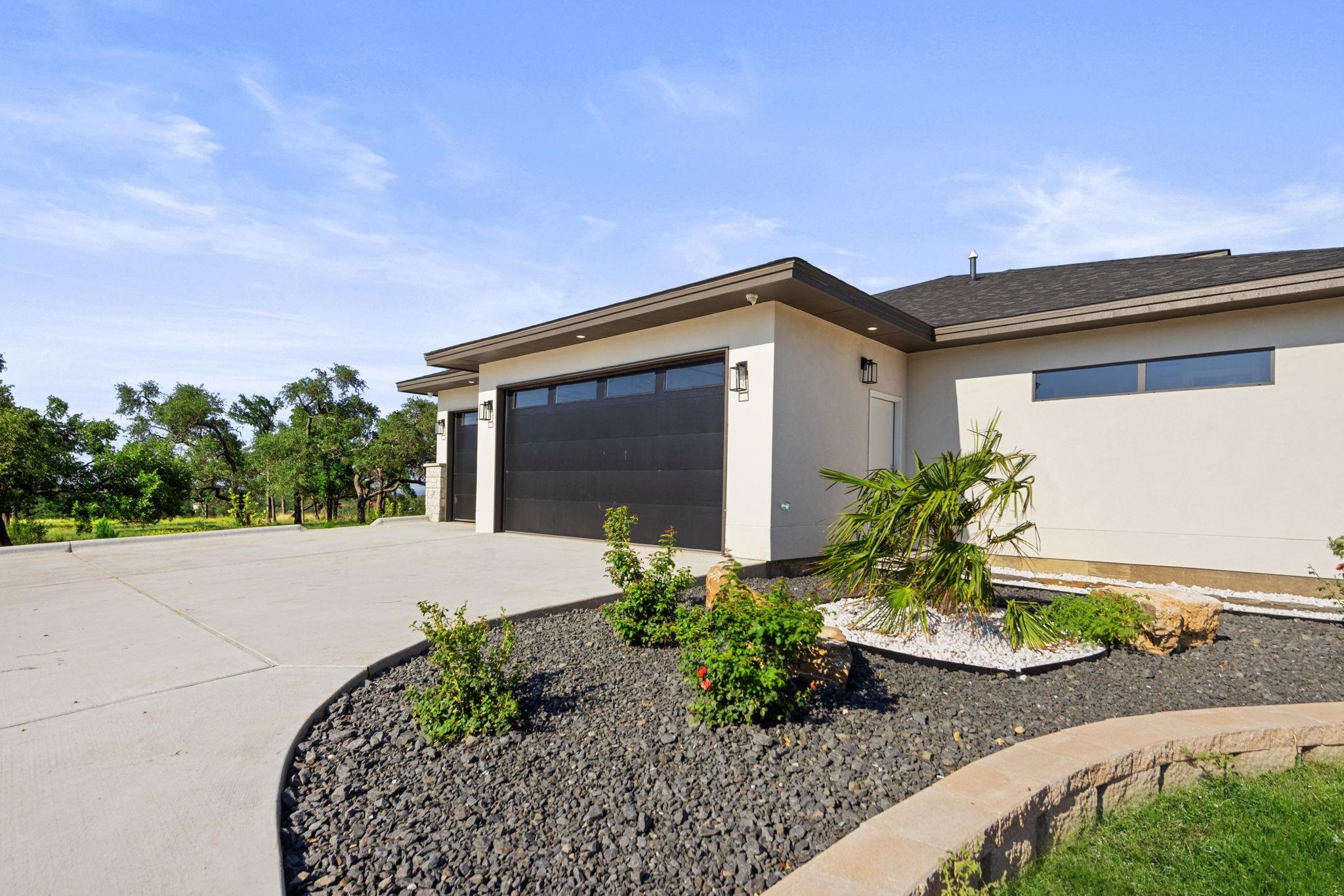 583 Comanche Ridge Round Mountain, TX 78663 - Photo 3 of 30 a front view of a house with garden