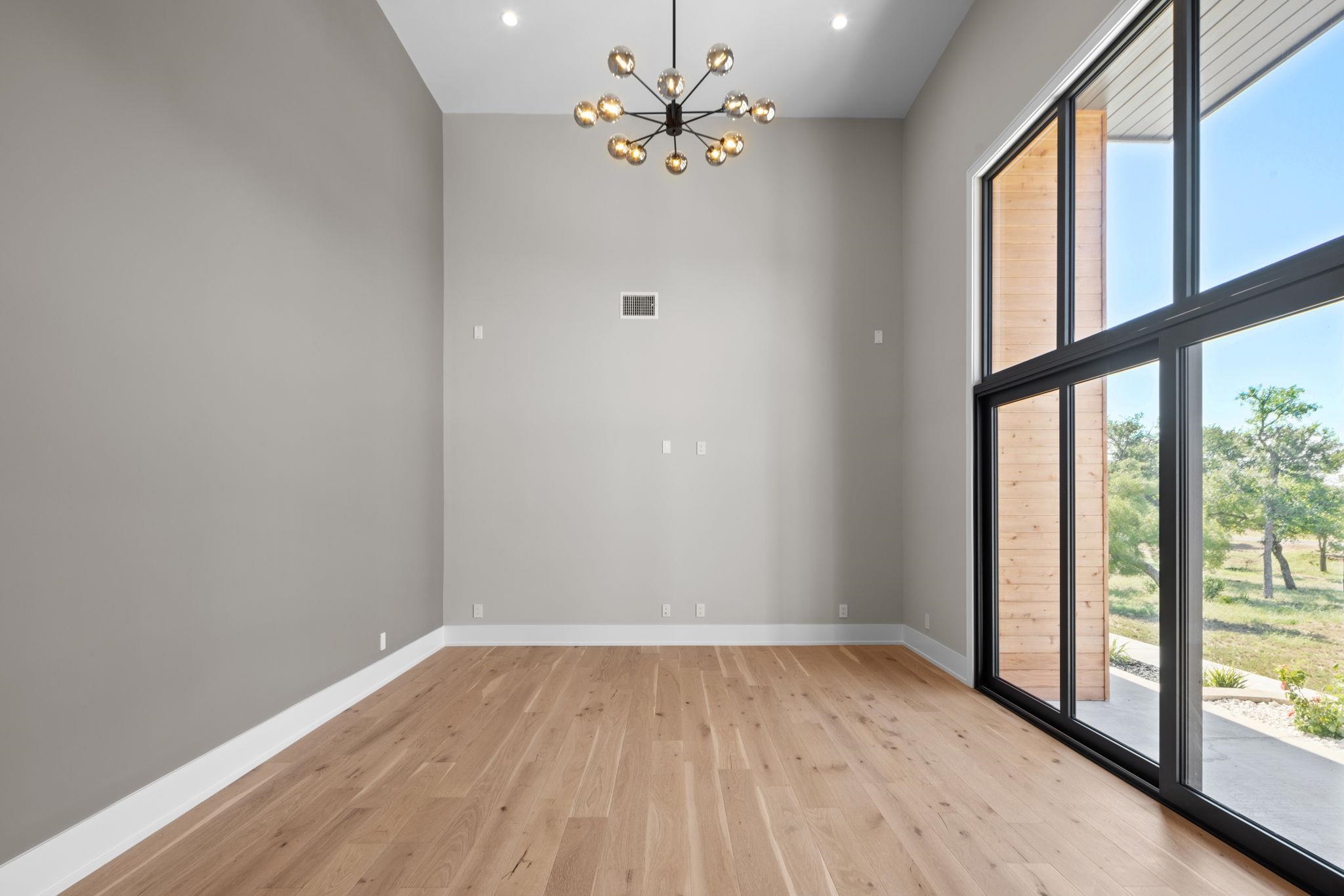 583 Comanche Ridge Round Mountain, TX 78663 - Photo 6 of 30 wooden floor in an empty room with a window