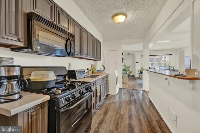 a kitchen with stainless steel appliances granite countertop a stove and a sink