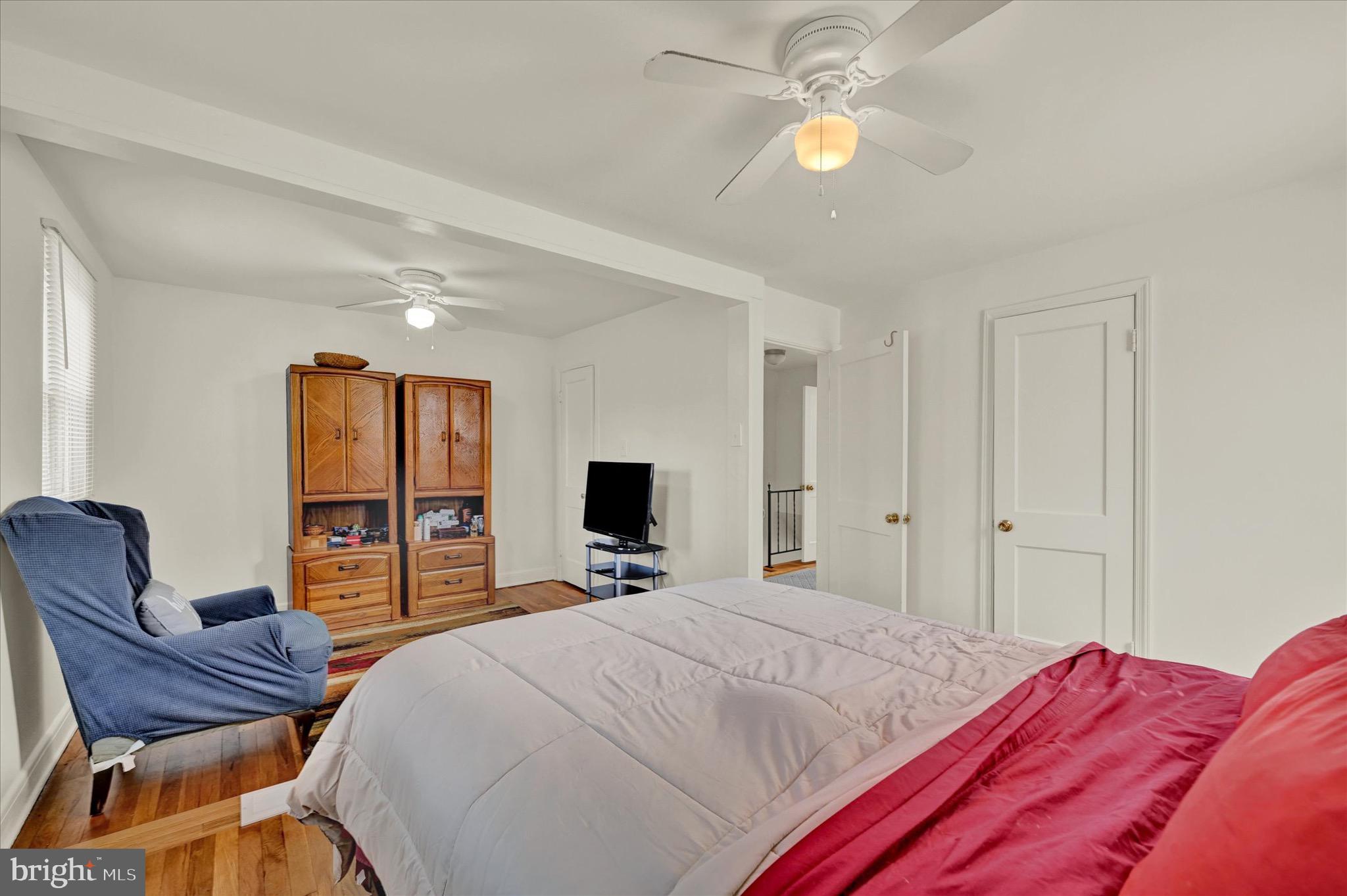 3922 Mortimer Avenue Baltimore, MD 21215 - Photo 16 of 27 a bedroom with a bed and furniture with outer view