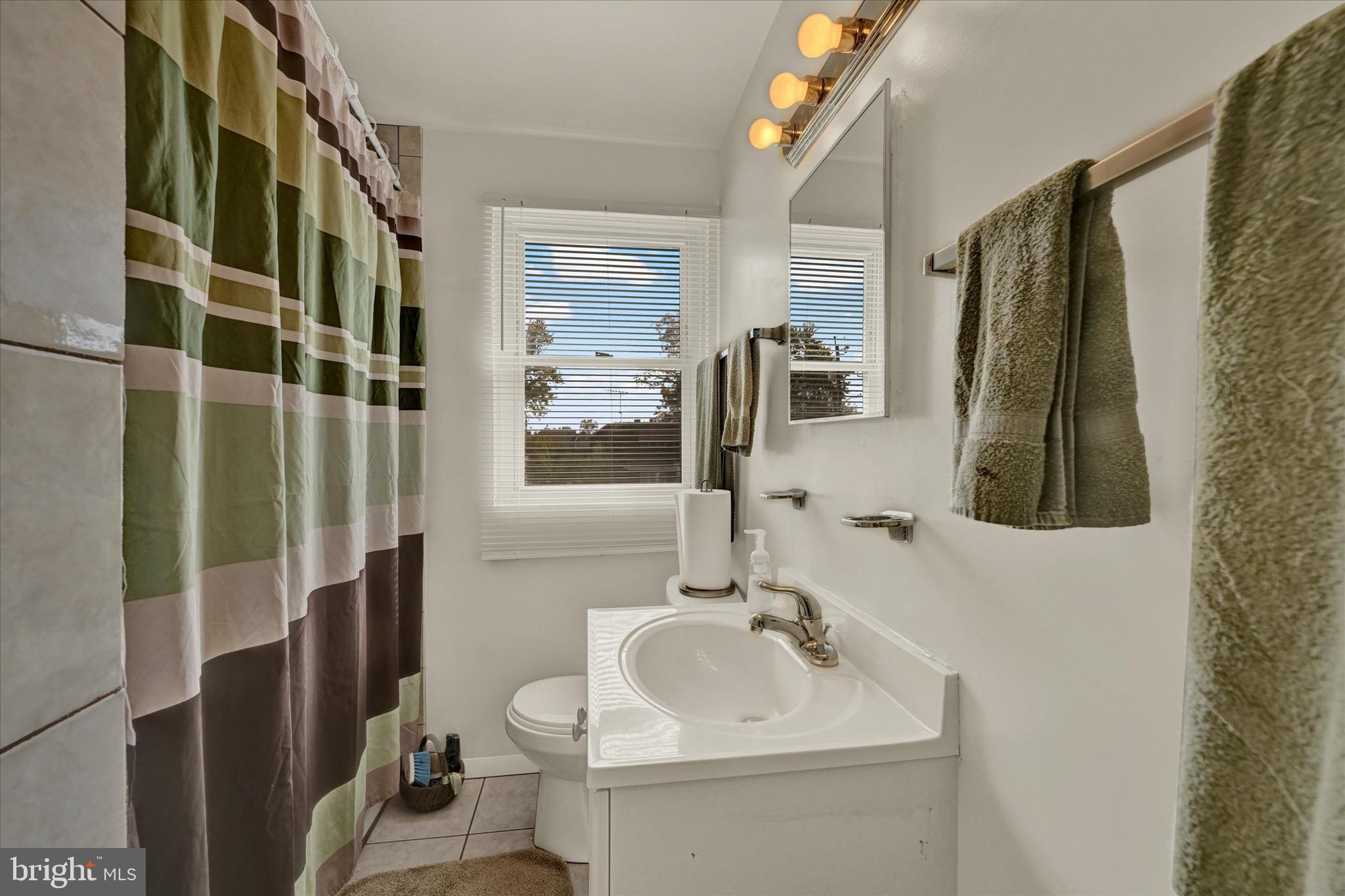 3922 Mortimer Avenue Baltimore, MD 21215 - Photo 17 of 27 a bathroom with a sink toilet and shower