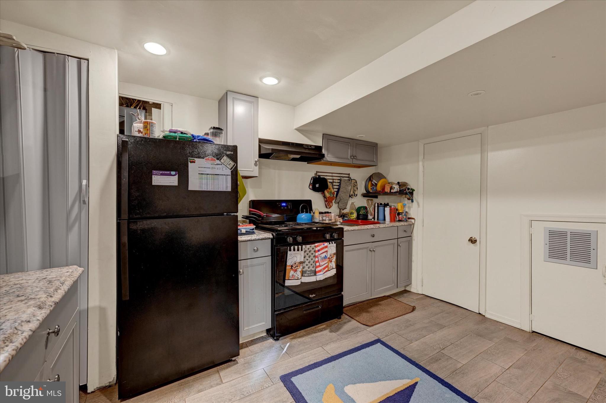 3922 Mortimer Avenue Baltimore, MD 21215 - Photo 19 of 27 a kitchen with a refrigerator stove and sink