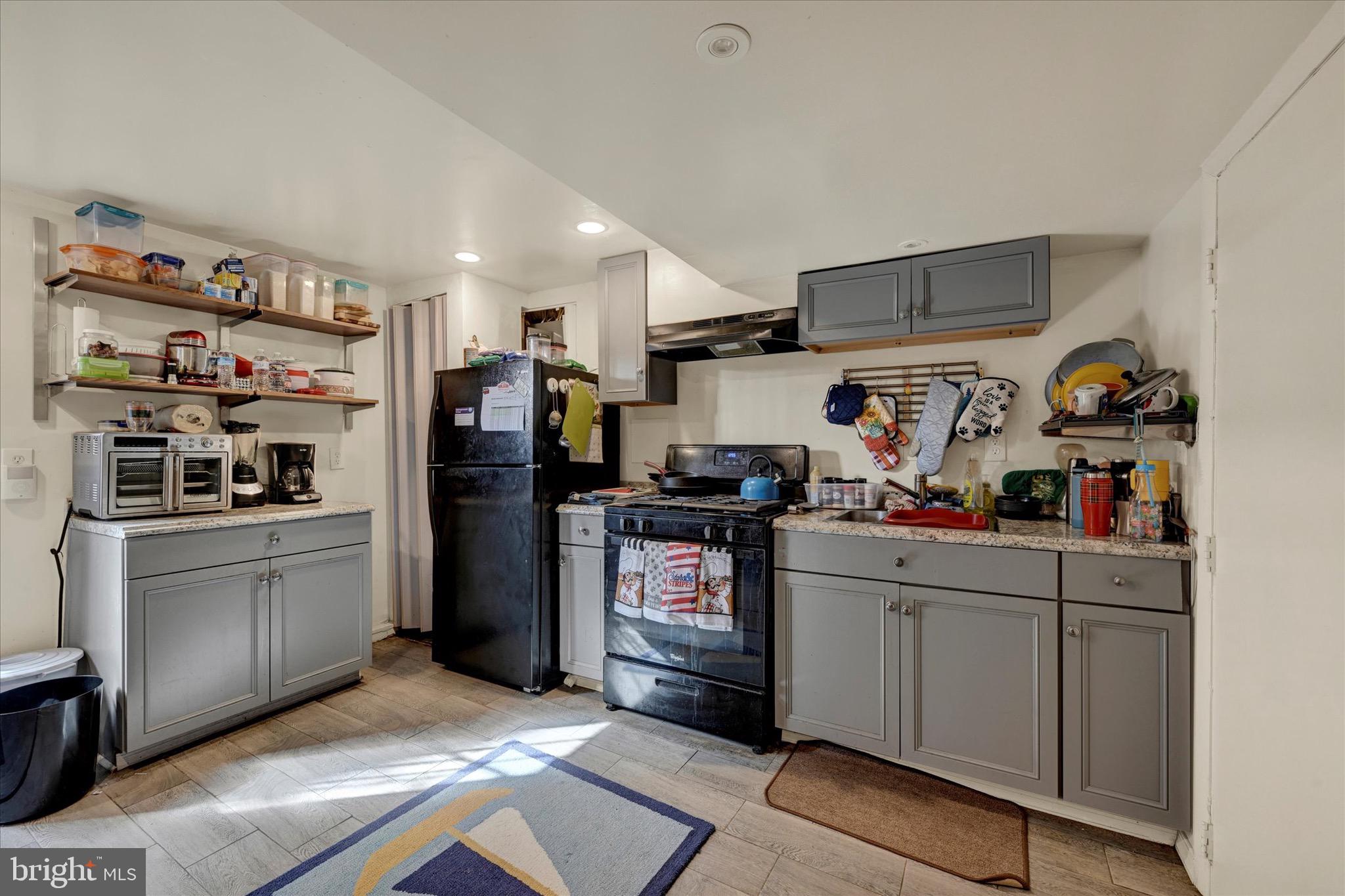 3922 Mortimer Avenue Baltimore, MD 21215 - Photo 20 of 27 a kitchen with refrigerator and cabinets