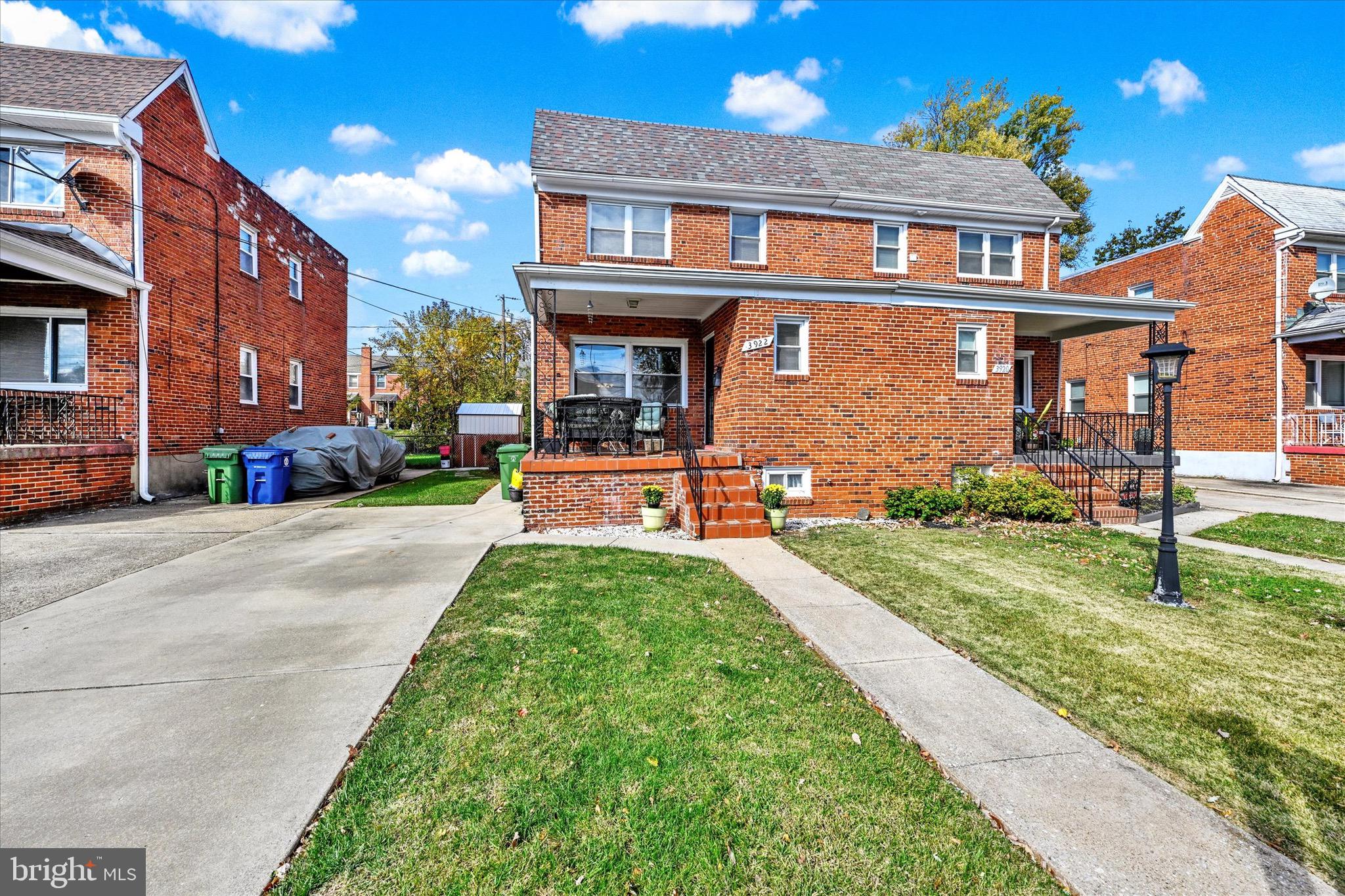 3922 Mortimer Avenue Baltimore, MD 21215 - Photo 2 of 27 a front view of a house with a yard